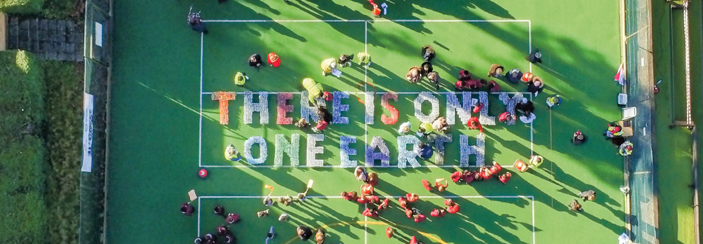 The words There is only one earth, are spelled out with plastic bottles.