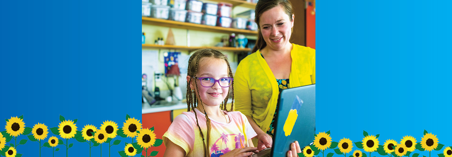 Image of a student with tablet and her teacher surrounded by a border of sunflowers